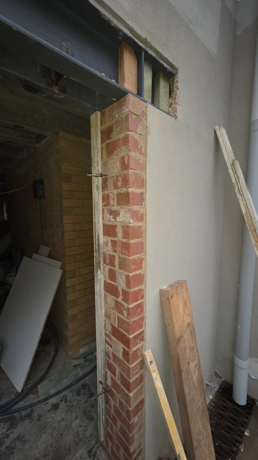 Rendered wall detail beside exposed brickwork