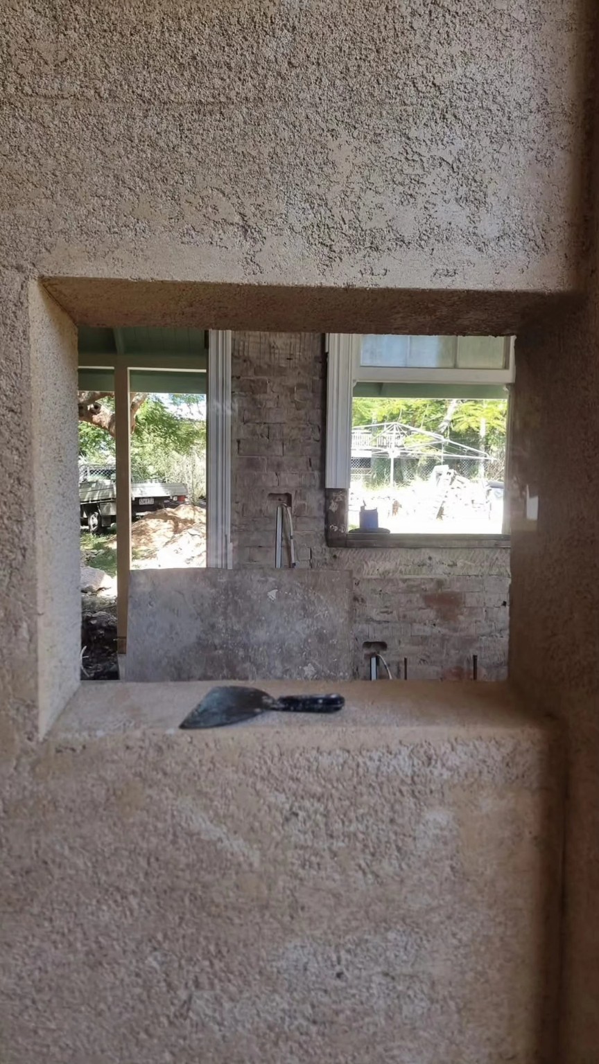 Textured solid plaster render around an opening